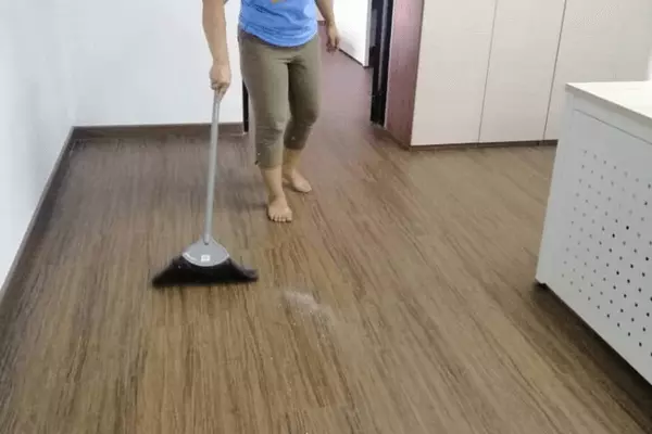 Contractual Cleaning Services - A person from JSS Mewah Cleaning Floor With Vacuum Cleaner